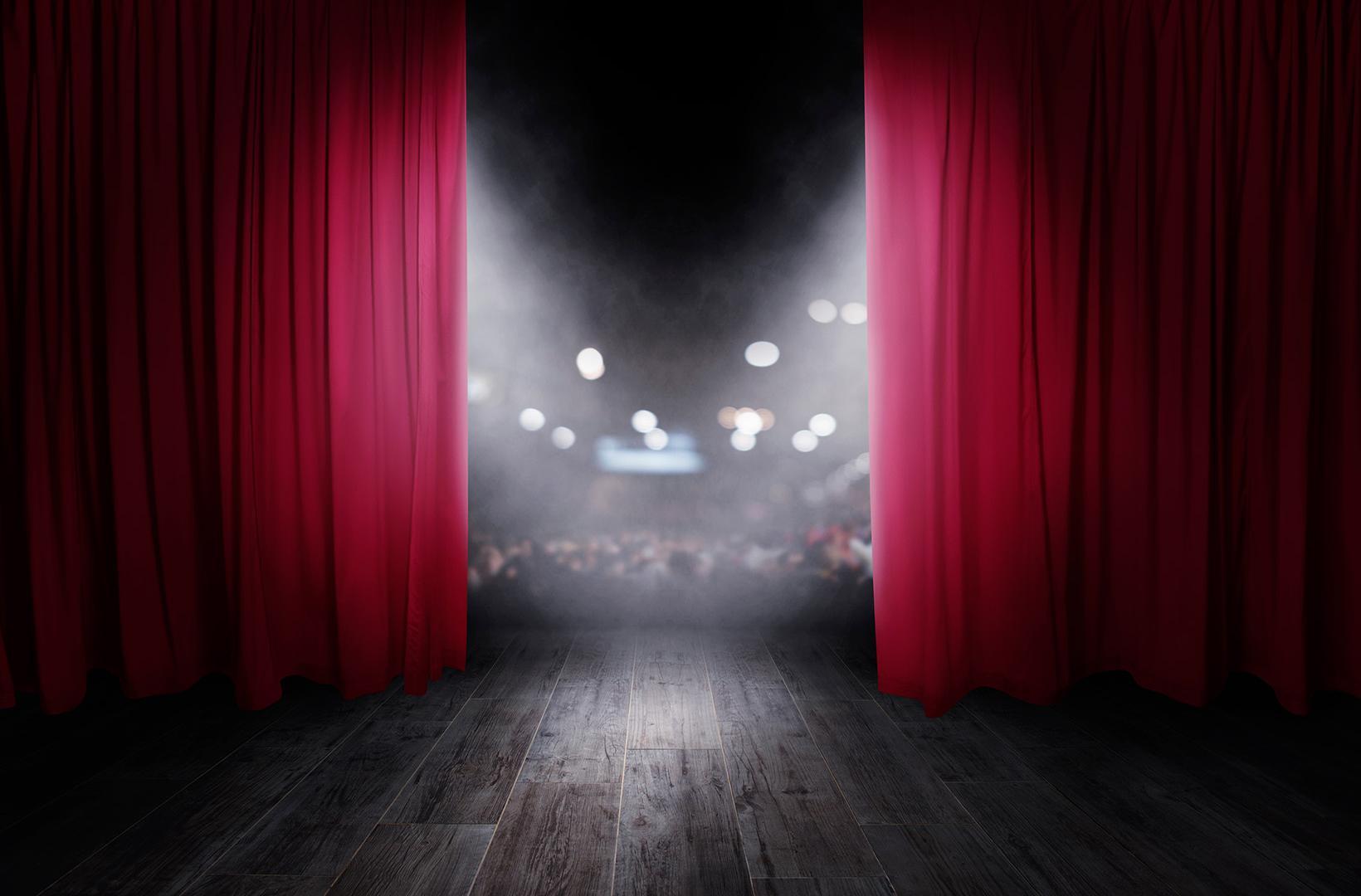 stage with curtains opening, looking out onto the audience