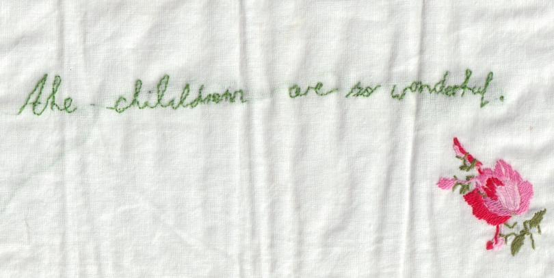 hand embroidery of text and flower. All children are wonderful.