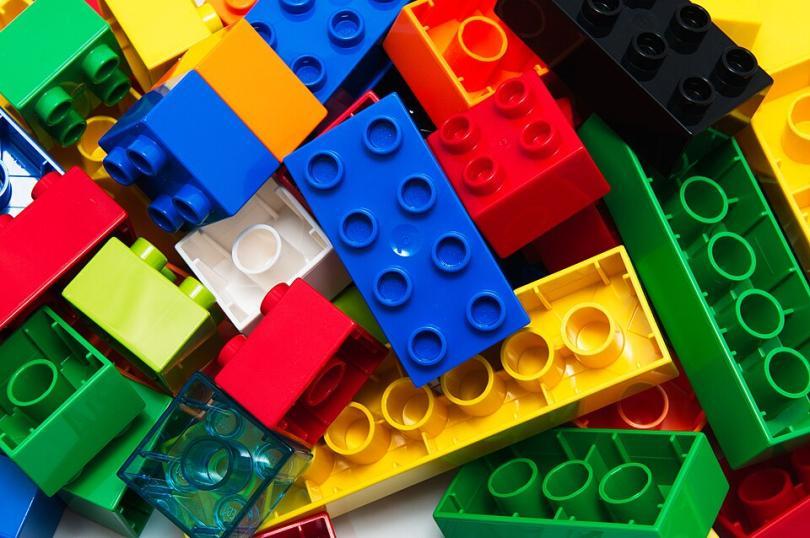 Image of assorted LEGO bricks - red, yellow, green, blue, white and brown. 