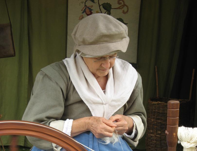 17th century re-enactment - a woman weaving.