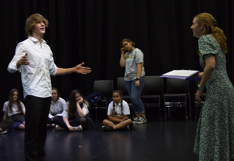 Young performers being guided by their performance tutor