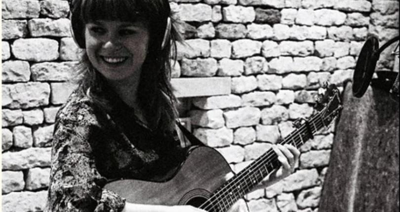 Katie Spencer plays guitar