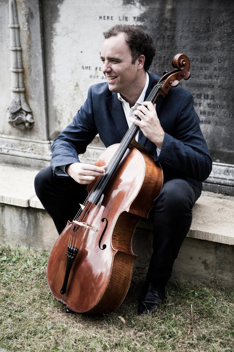 Adrian Brendel sitting with his cello