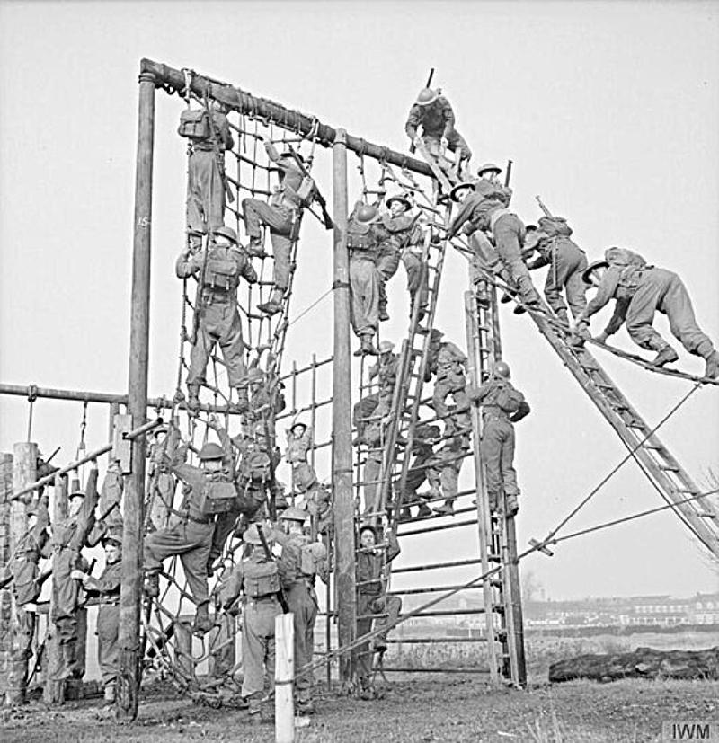 soldiers tacking the nets on an assault course