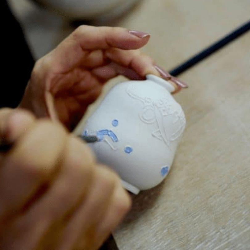 Hand painting a pot
