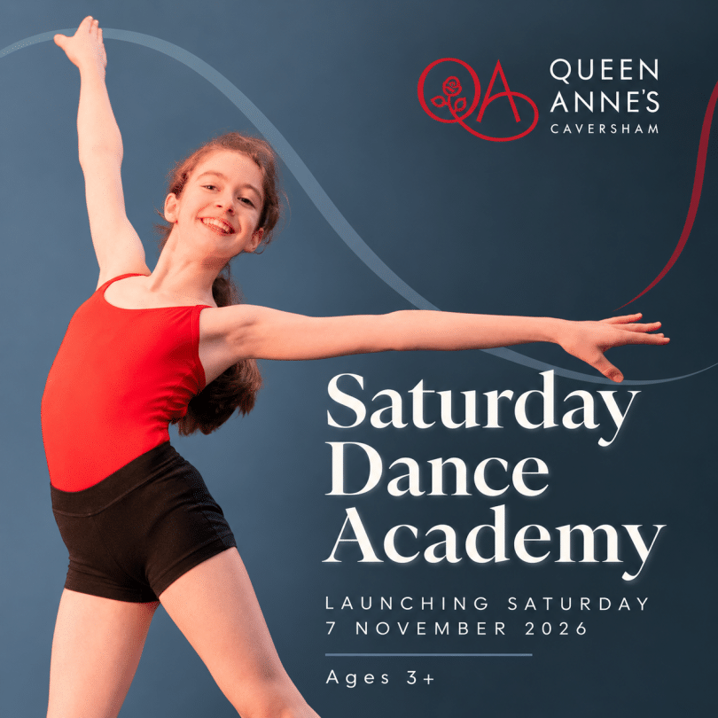 Girls in red leotard and black shorts performing a dance move with arms outstretched