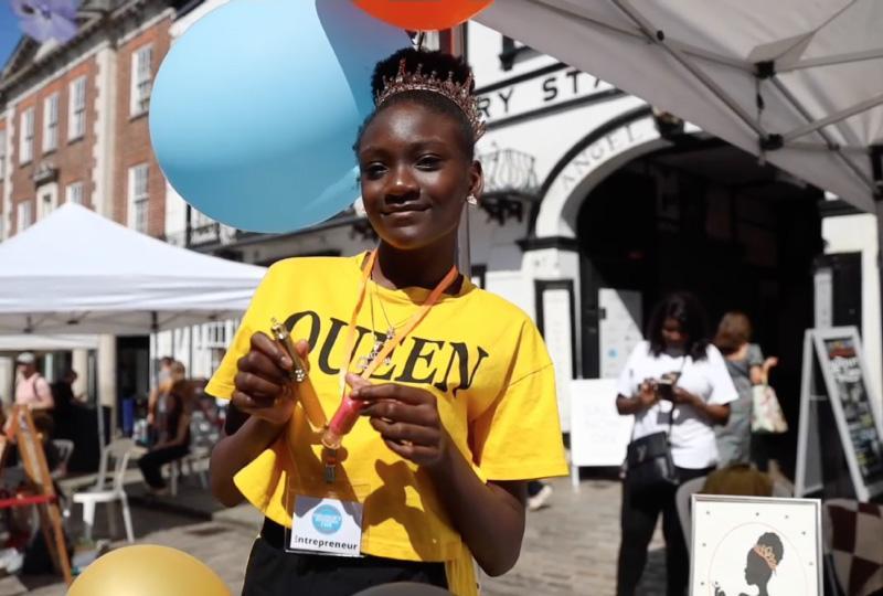 Black teenage girl wearing a queen t-shirt 