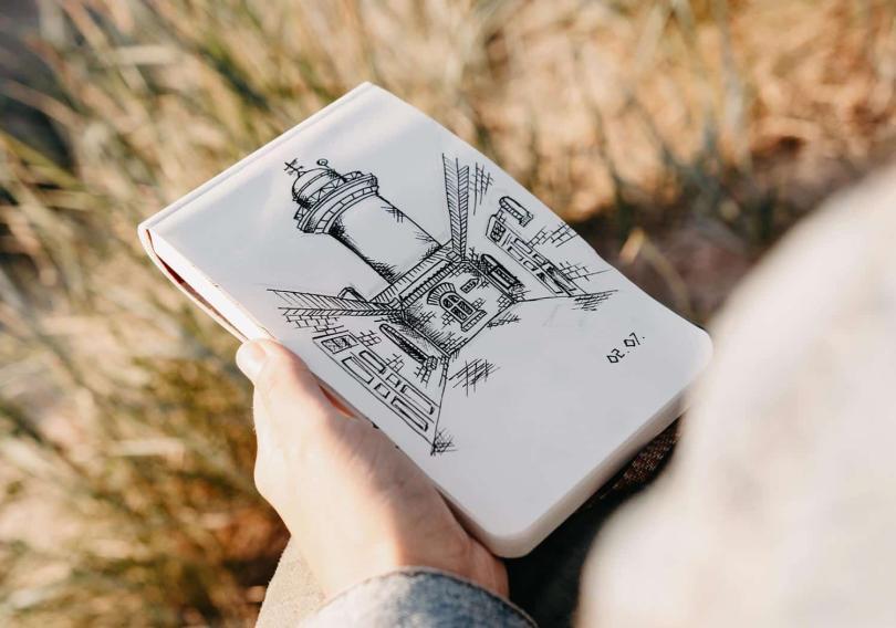 Detail of person sketching on a pad