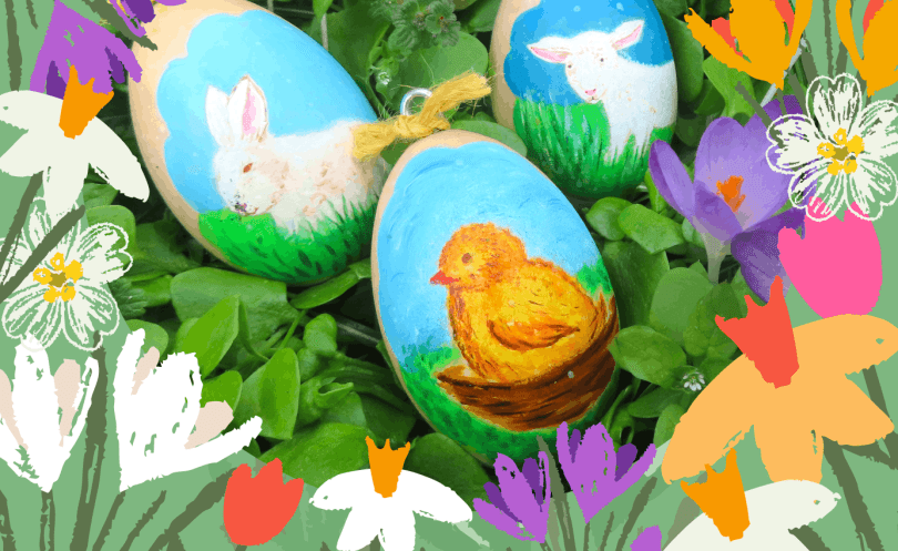 Painted Easter eggs lying in grass and flowers