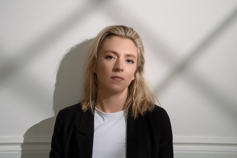 Hannah Scott against white wall