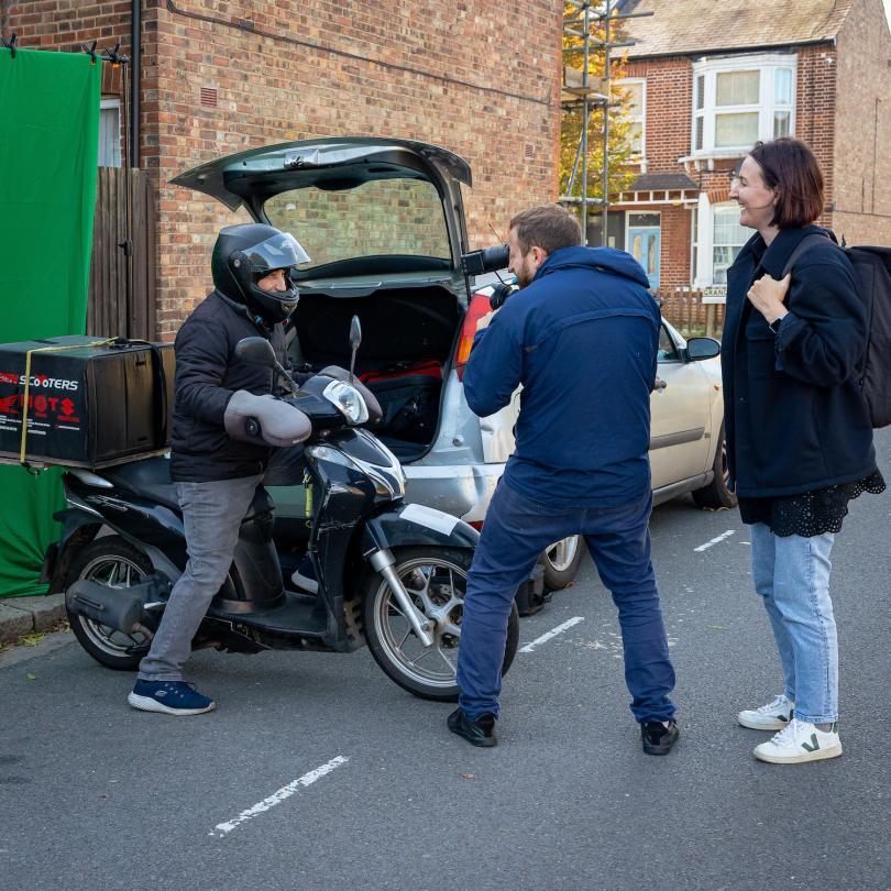 director and camera man shooting a scene with a motorcycle