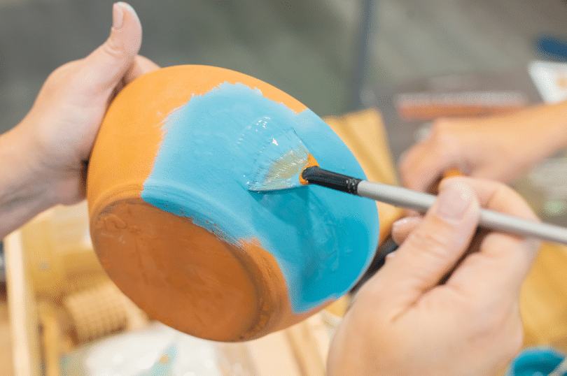 Hand painting a pot