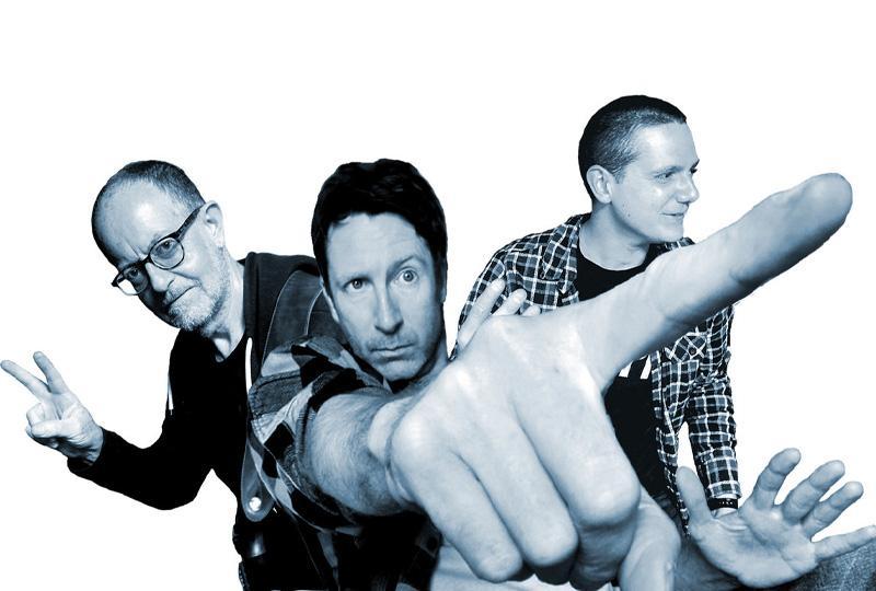 black and white photo of Jon Amor band with some interesting perspective so that the central man's pointing finger is really big