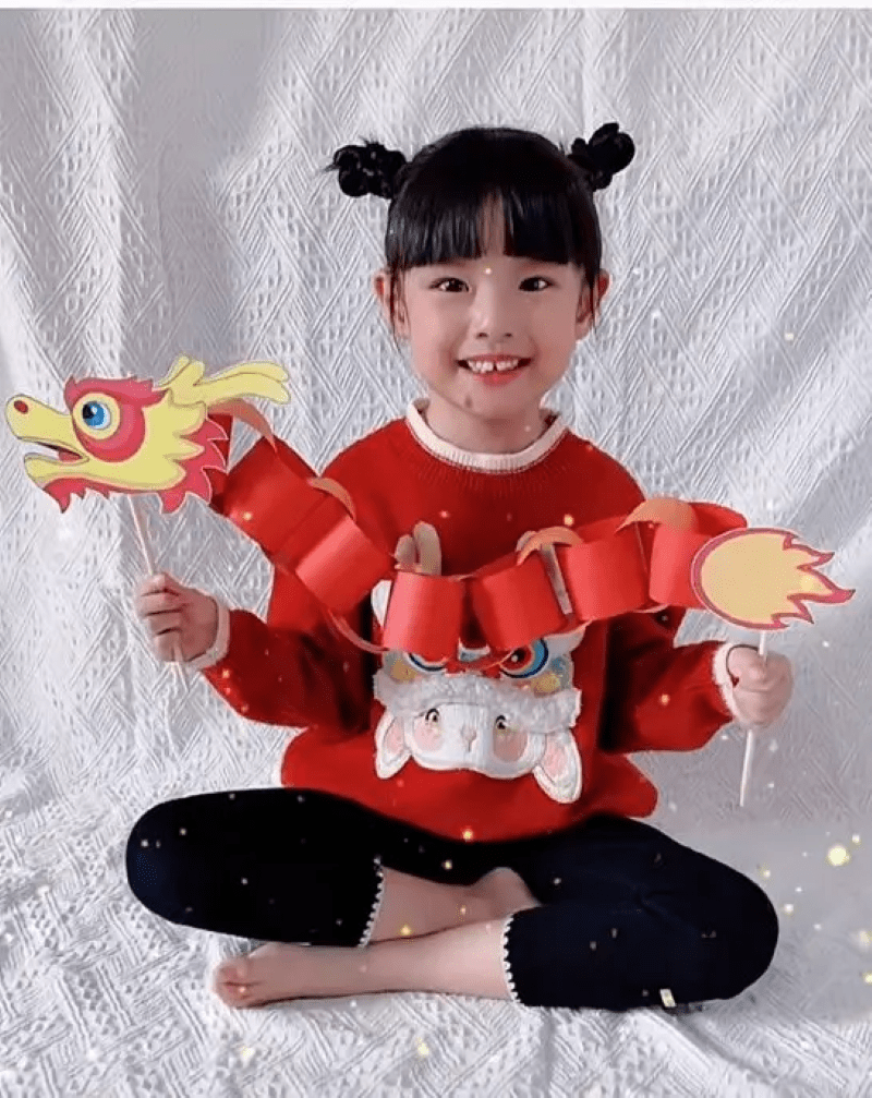 Girl holding a paper chain Chinese dragon