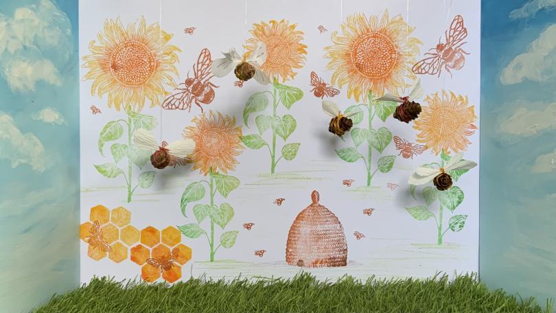 picture of handmade bees with painted flowers in the background