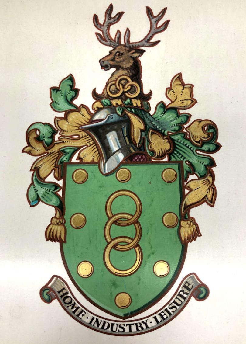 Bracknell Coat of Arms green in colour with stag on top and words Home Industry Leisure at the botoom