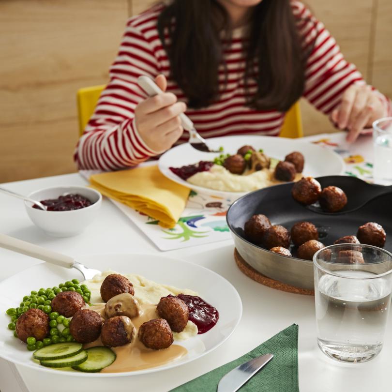 Table set with plates of IKEA Swedish meatballs 