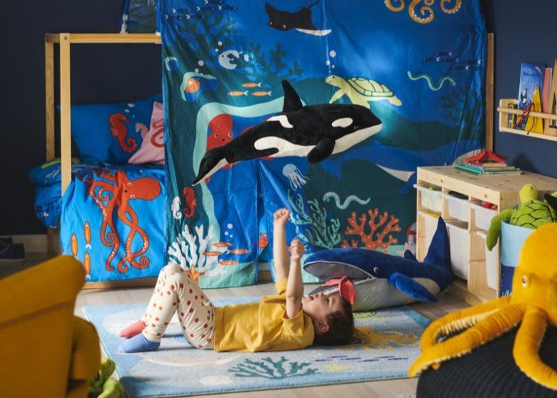 Child laying in their ocean themed bedroom 