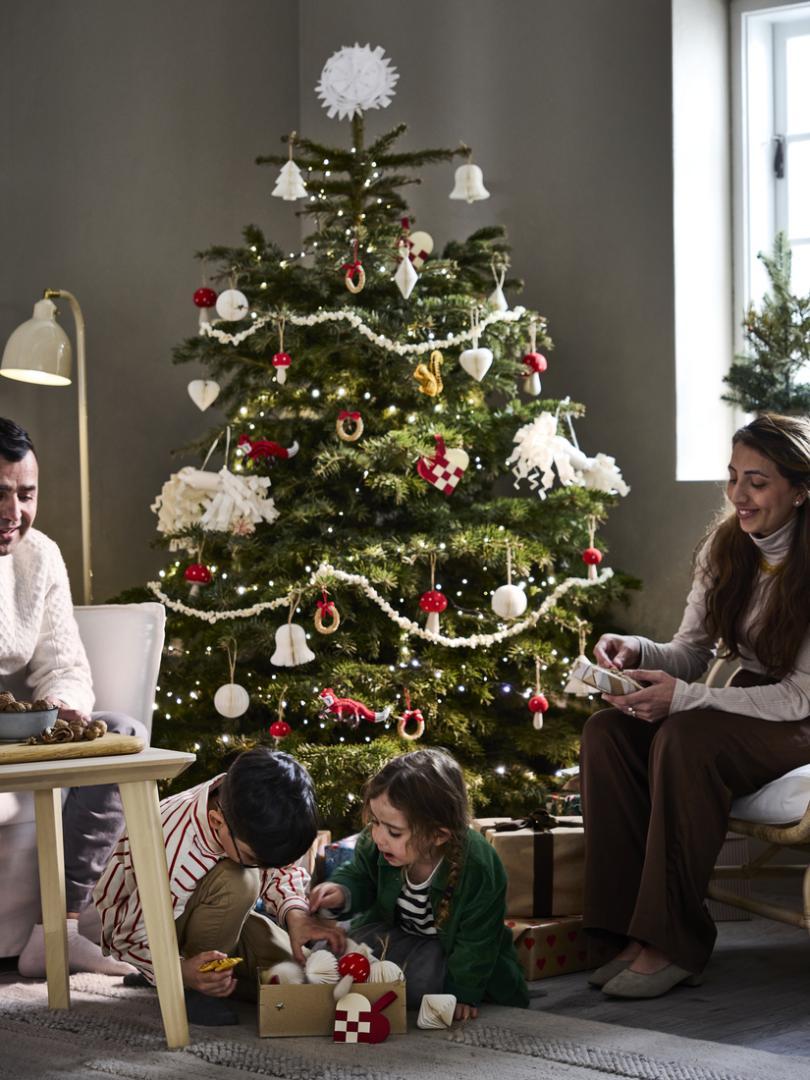 Family gathered around christmas tree