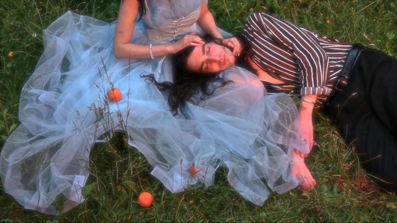 photo of a man and woman lying together in the grass