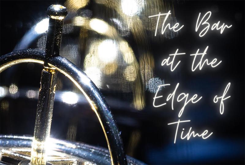 Close-up photograph of a shiny silver metal object. There is a row of identical objects in the background, out of focus. To the right of the object is text overlaid onto the image, it is white and glowing like a neon sign. Text reads 'The Bar at the Edge of Time'