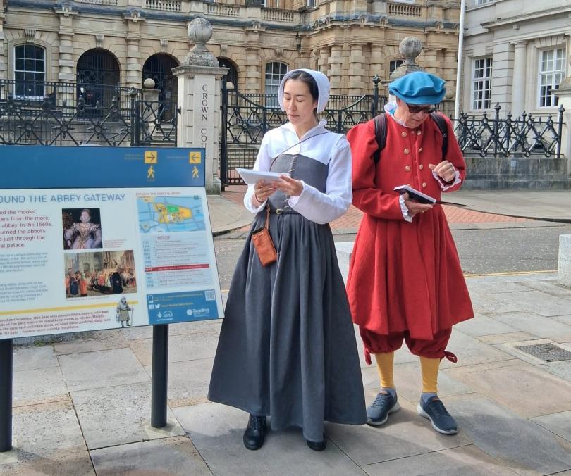 2 people dressed in tudor costumes