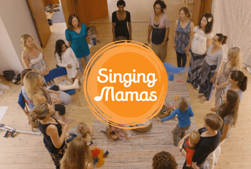 Image of women singing in a circle and Singing Mamas logo