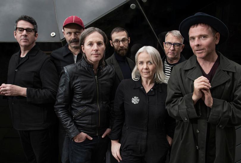 Members of the band Belle and Sebastian wearing black and charcoal clothes