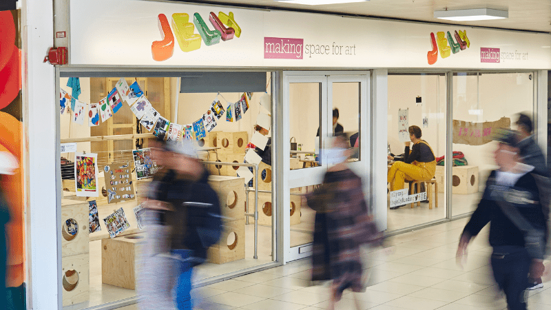 Jelly shop front with blurred images of people walking past