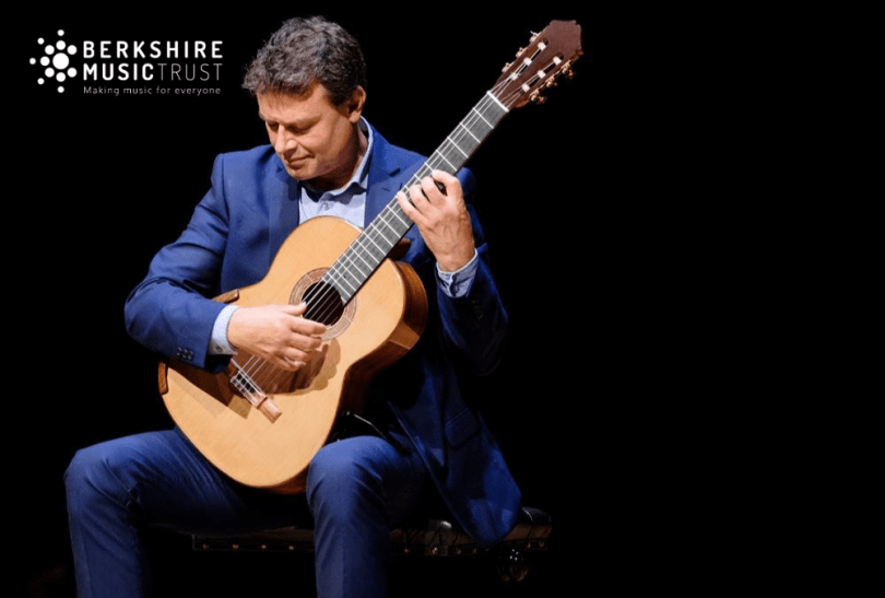 Craig Ogden holding a guitar on a black background and the Berkshire Music Trust logo