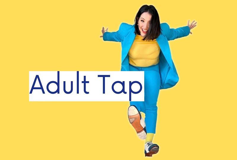 A woman in a bright blue suit posing and showing off her tap shoes