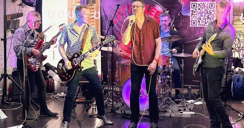 Five musicians on stage