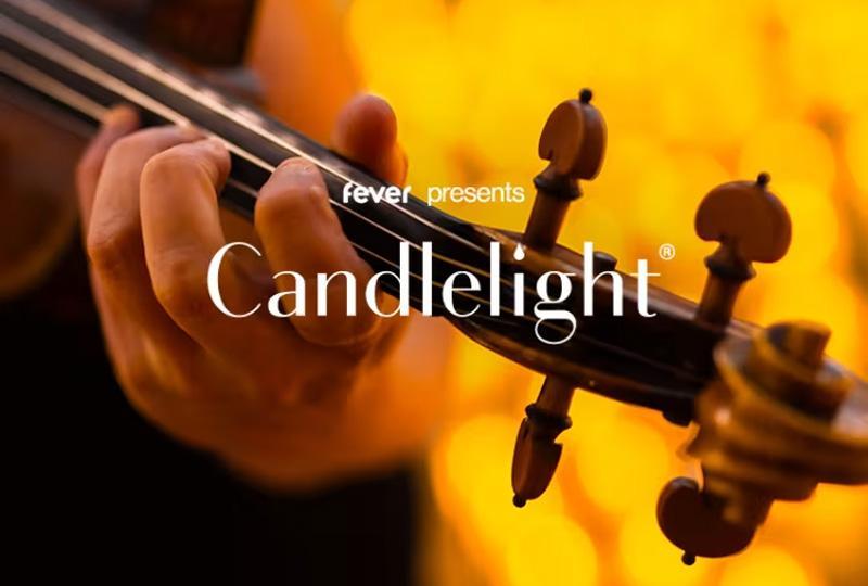 The words "fever presents Candlelight" over a close up image of a man playing a violin