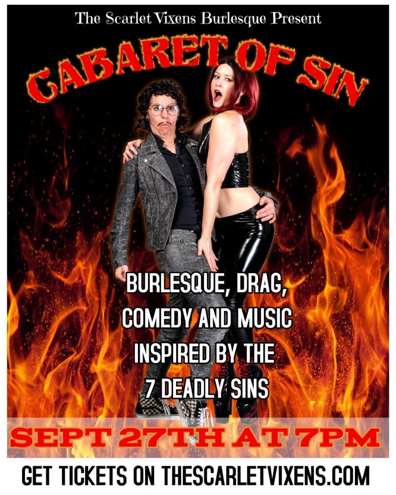 Drag King and burlesque performer in front of some images of flames