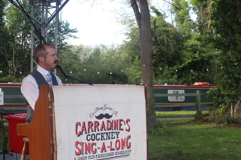 Tom Carradine sitting at a piano