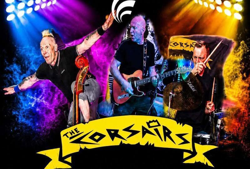 The rockabilly musicians playing bass, gutar and drums respectively, over the Corsairs band logo