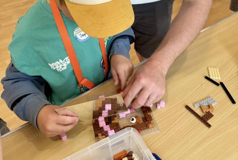 Parent and child building with LEGO