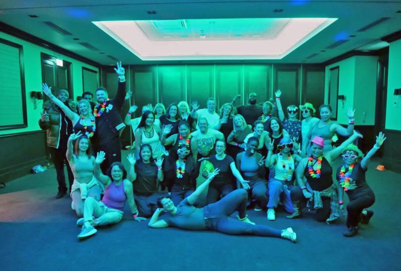 Dance class participants in a big group pose