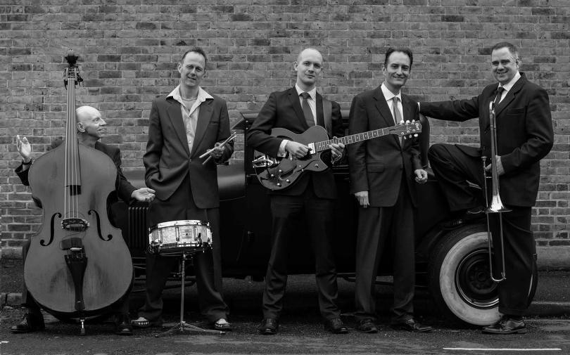 five-piece swing band holding their instruments