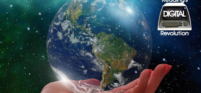 A hand holding the Earth