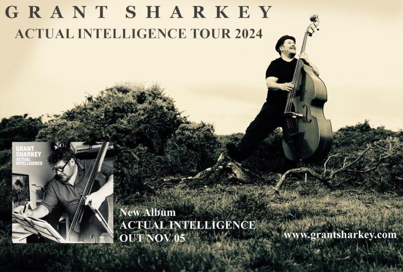 grant sharkey in a pork pie hat and black clothes holding a double bass