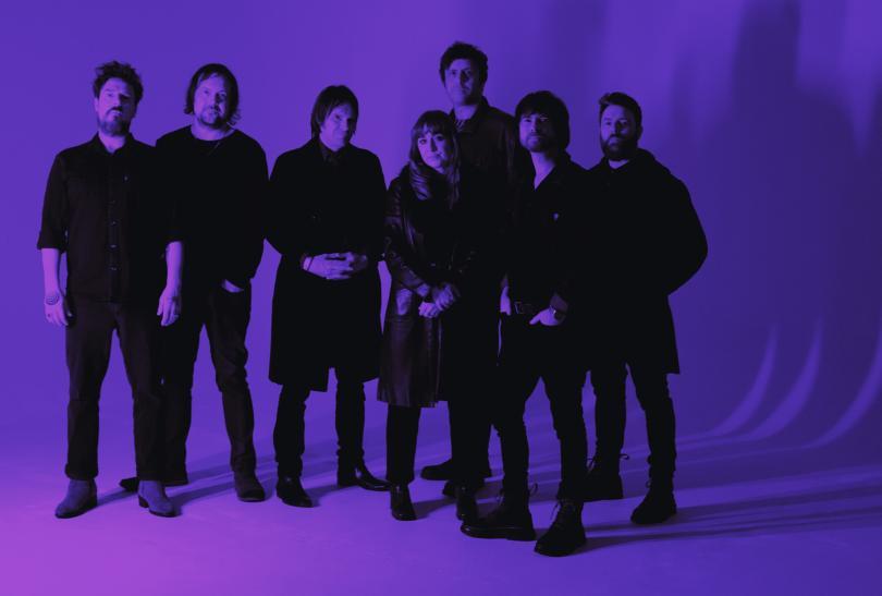 Purple monochrome photo of the band Helicon