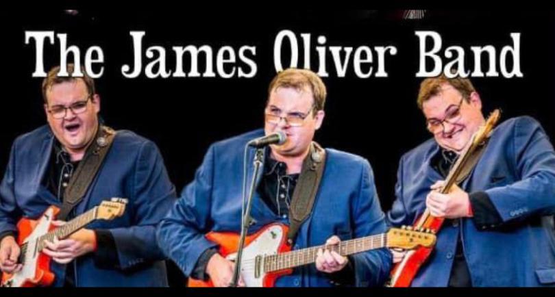three James Oliver's - a bespectabled man playing guitar in a blue suit