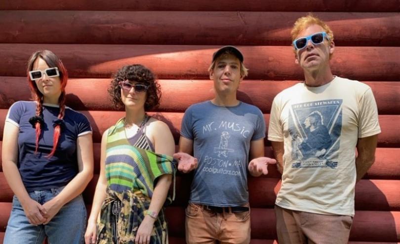 Band members of  Jeffrey Lewis & The Voltage lined up against a wall