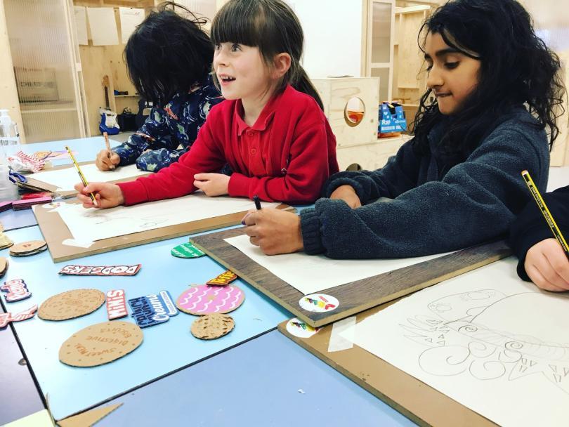 three children drawing