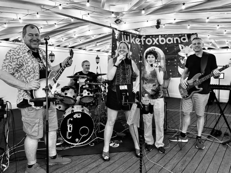 Photos of the five members of Jukfox, each playing their respective instruments