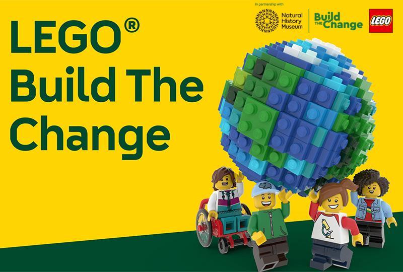 Lego figures holding a LEGO globe