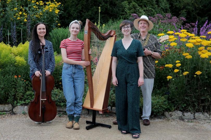 Folk band Moonrakers - three women and a man, holding a cello, harp and mandola