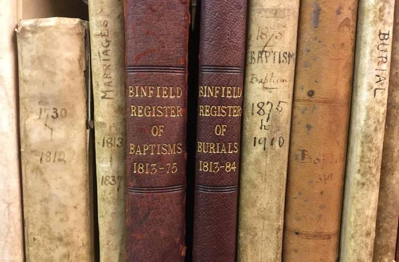 The spines of parish registers for Binfield, Berkshire, in the strong room of the Berkshire Record Office.