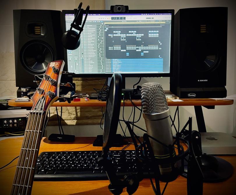 Guitars and microphones in front of a computer